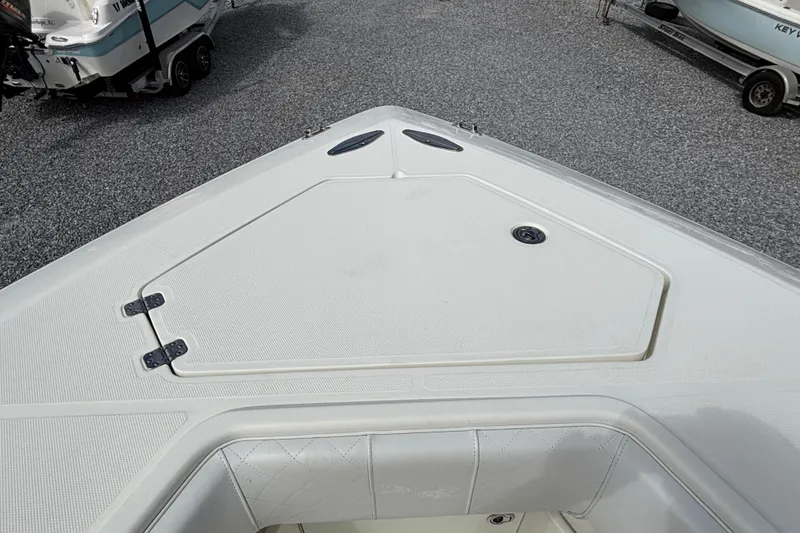 Slide: The Image of 2018 SeaVee 390Z boat deck with storage hatch, parked on gravel. - 28