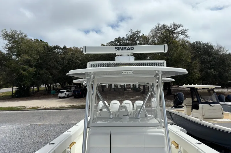 Slide: The Image of 2018 SeaVee 390Z boat with Simrad radar, parked outdoors under cloudy skies. - 33