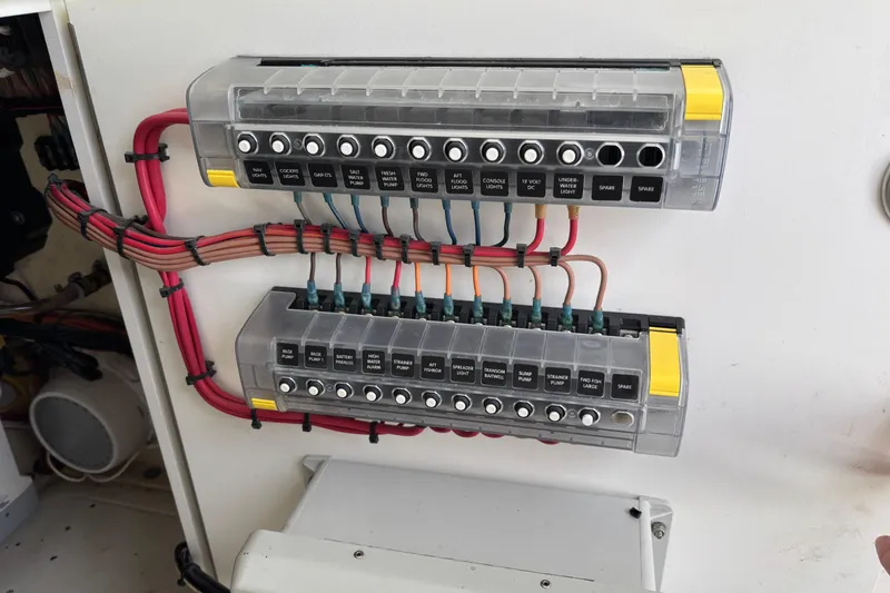 Slide: The Image of Electrical panel with labeled switches and wiring on a 2018 SeaVee 390Z boat. - 38