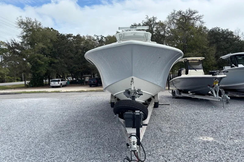 Slide: The Image of 2018 SeaVee 390Z boat on trailer, parked outdoors with trees in background. - 4