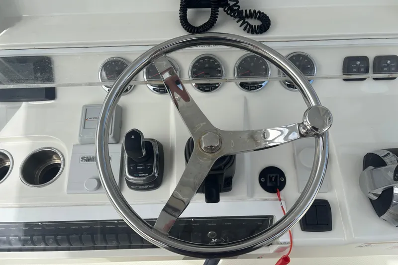 Slide: The Image of Steering wheel and controls of a 2018 SeaVee 390Z boat dashboard. - 7