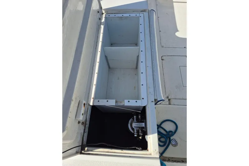 Slide: The Image of Open storage compartment on a 1987 Mako 261 Center Console boat deck. - 16