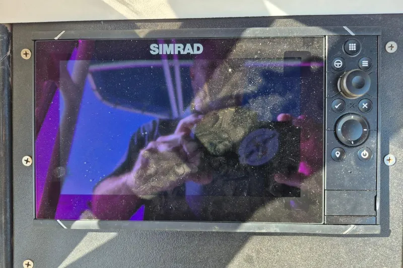Slide: The Image of Simrad marine display on 1987 Mako 261 Center Console boat dashboard. - 18