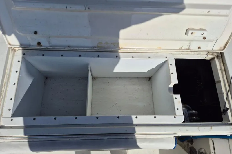 Slide: The Image of Open storage compartment on a 1987 Mako 261 Center Console boat. - 27