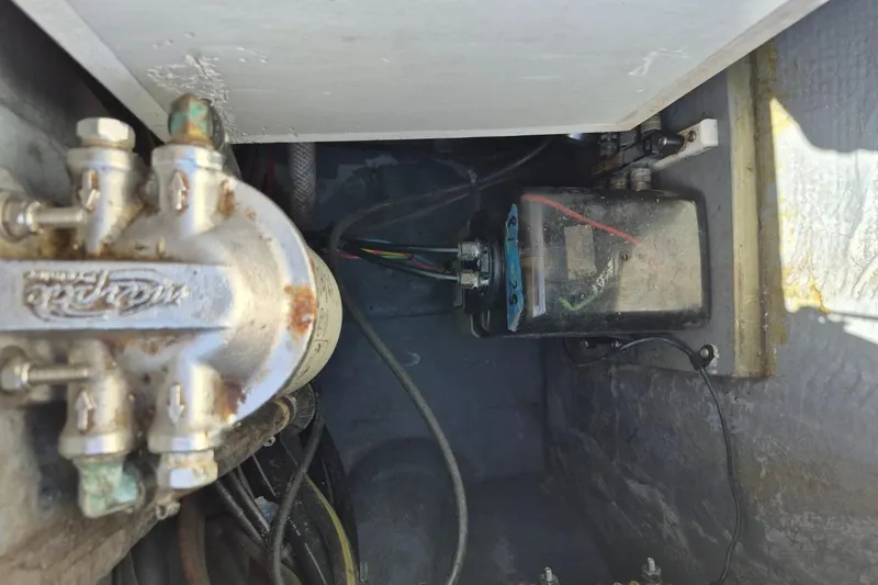 Slide: The Image of 1987 Mako 261 Center Console engine compartment with visible wiring and components. - 28