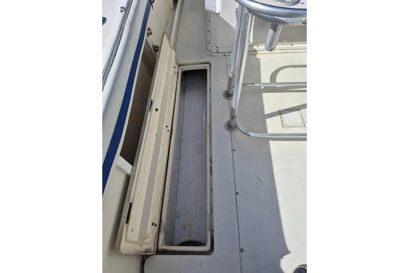 Slide: The Image of 1987 Mako 261 Center Console boat interior with open storage compartment. - 30