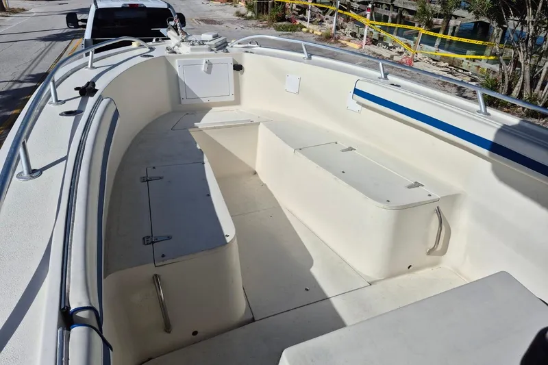 Slide: The Image of 1987 Mako 261 Center Console boat interior with seating and storage compartments. - 32