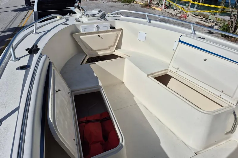 Slide: The Image of 1987 Mako 261 Center Console boat with open storage compartments on deck. - 33