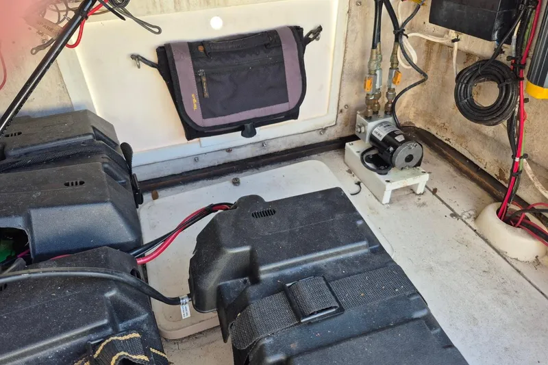 Slide: The Image of Interior of a 1987 Mako 261 Center Console boat showing battery compartments and wiring. - 43