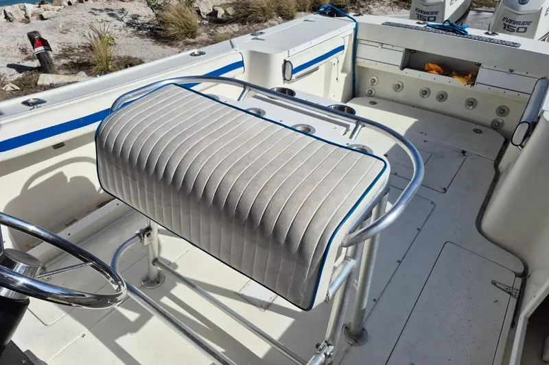 Slide: The Image of 1987 Mako 261 Center Console boat interior with steering wheel and seating. - 46