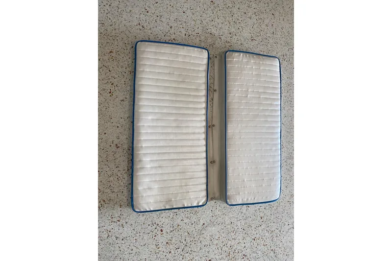 Slide: The Image of White boat cushions for 1987 Mako 261 Center Console on speckled floor. - 48