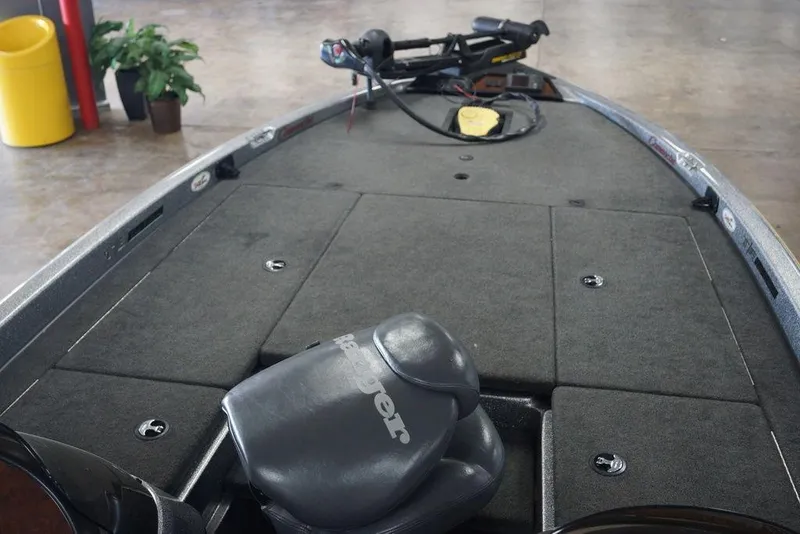 Slide: The Image of 2006 Ranger 521 VX boat interior with carpeted deck and trolling motor. - 10