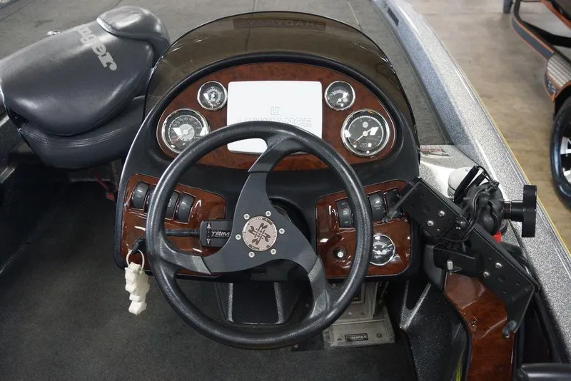 Slide: The Image of 2006 Ranger 521 VX boat dashboard with steering wheel and instrument panel. - 13