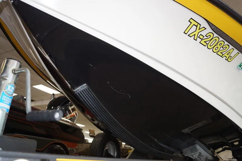 Slide: The Image of 2006 Ranger 521 VX boat hull with registration TX-2082AJ, displayed indoors. - 3