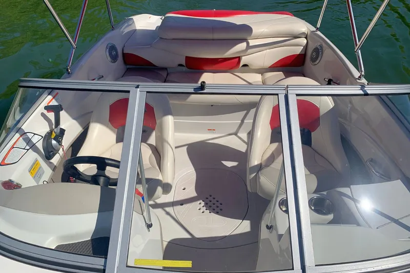 Slide: The Image of Interior of a 2012 Tahoe Q5i boat with red and white seating. - 13