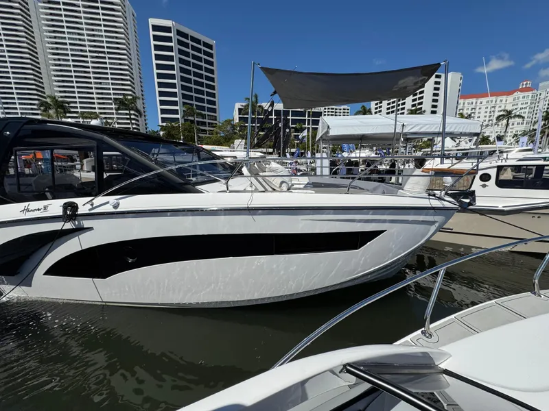 Slide: The Image of 2025 Hanover 387 yacht docked at marina with modern buildings in background. - 13