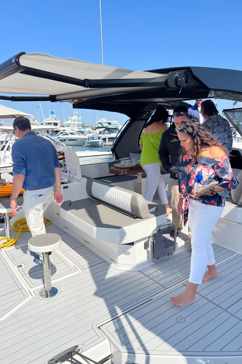 Slide: The Image of People exploring the 2025 Hanover 387 yacht at a marina. - 18