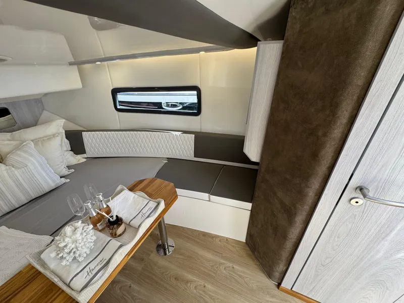 Slide: The Image of Luxurious interior of 2025 Hanover 387 yacht with elegant seating and dining setup. - 6