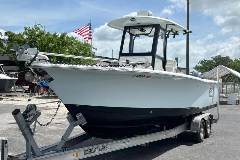The Image of 2018 Sea Hunt Gamefish 27 boat on trailer, American flag in background. - 0
