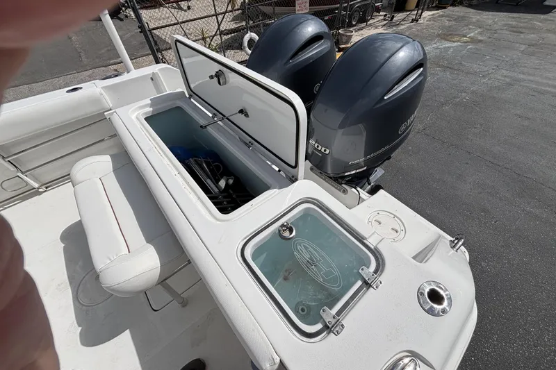 Slide: The Image of 2018 Sea Hunt Gamefish 27 boat with open storage and twin Yamaha engines. - 14