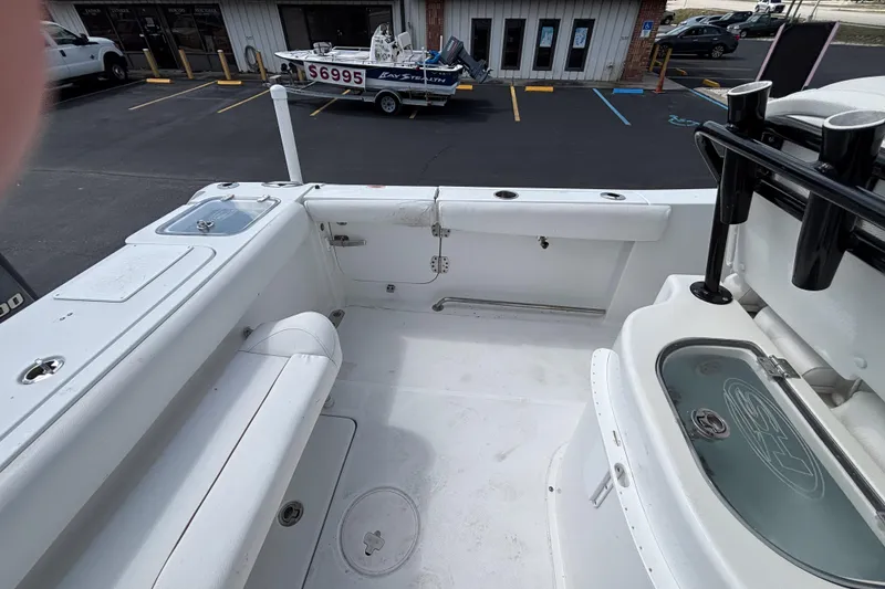 Slide: The Image of 2018 Sea Hunt Gamefish 27 boat interior with forward seating and fishing rod holders. - 19