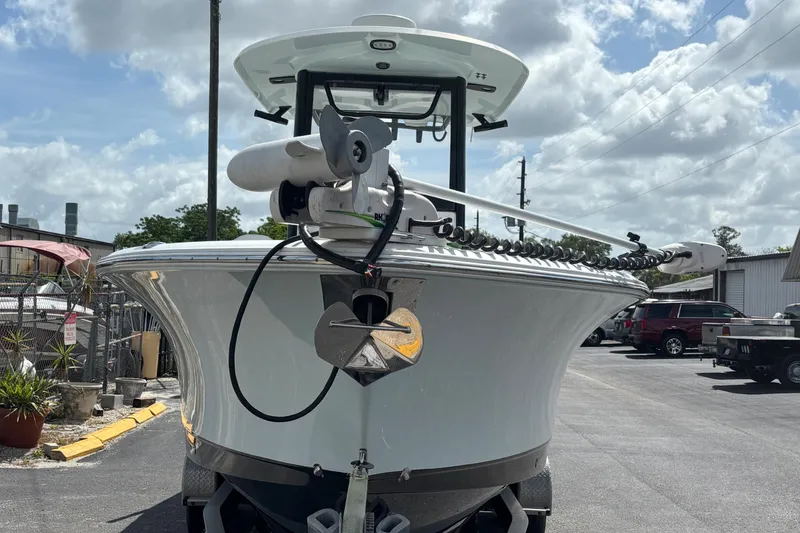 Slide: The Image of 2018 Sea Hunt Gamefish 27 boat with forward seating, parked outdoors under a cloudy sky. - 2