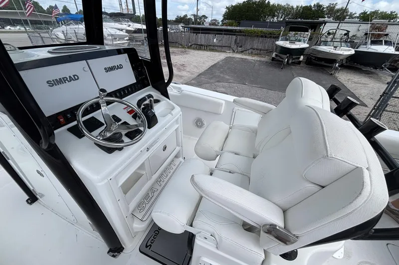 Slide: The Image of 2018 Sea Hunt Gamefish 27 helm with dual Simrad displays and white seating. - 21