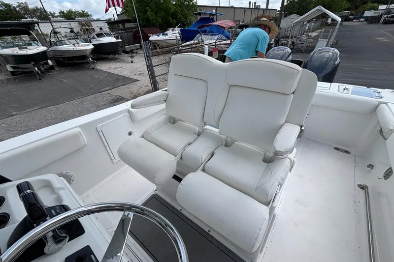 Slide: The Image of 2018 Sea Hunt Gamefish 27 boat with white forward seating and steering wheel. - 22