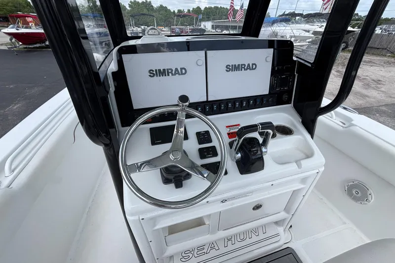Slide: The Image of 2018 Sea Hunt Gamefish 27 helm with dual Simrad displays and steering wheel. - 23