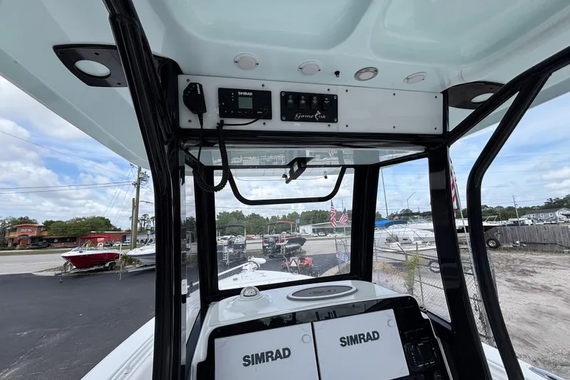 Slide: The Image of 2018 Sea Hunt Gamefish 27 boat dashboard with Simrad electronics and overhead controls. - 24