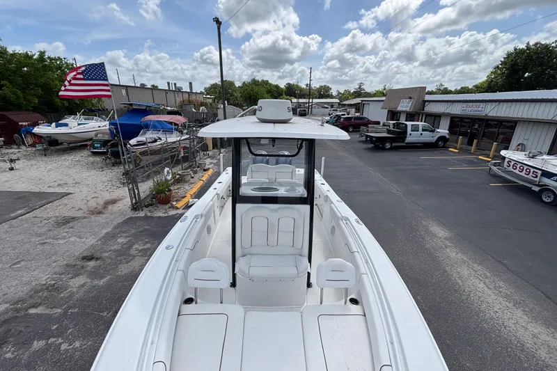 Slide: The Image of 2018 Sea Hunt Gamefish 27 boat with forward seating, parked in a marina lot. - 36
