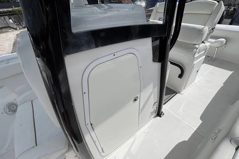 Slide: The Image of 2018 Sea Hunt Gamefish 27 Forward Seating interior with white seating and storage compartment. - 44