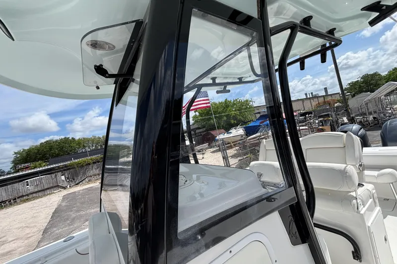 Slide: The Image of 2018 Sea Hunt Gamefish 27 boat with forward seating, docked under a clear blue sky. - 45