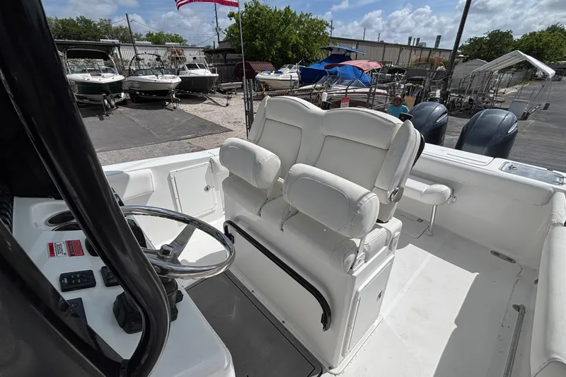 Slide: The Image of 2018 Sea Hunt Gamefish 27 boat with forward seating and dual engines at a marina. - 46