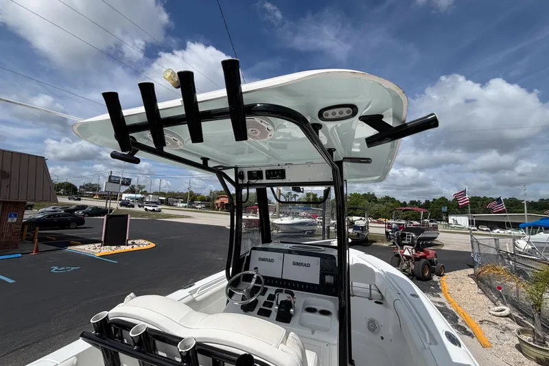 Slide: The Image of 2018 Sea Hunt Gamefish 27 boat with forward seating, featuring a sleek helm and rod holders. - 48