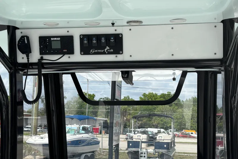 Slide: The Image of 2018 Sea Hunt Gamefish 27 dashboard with Simrad electronics and control panel. - 49