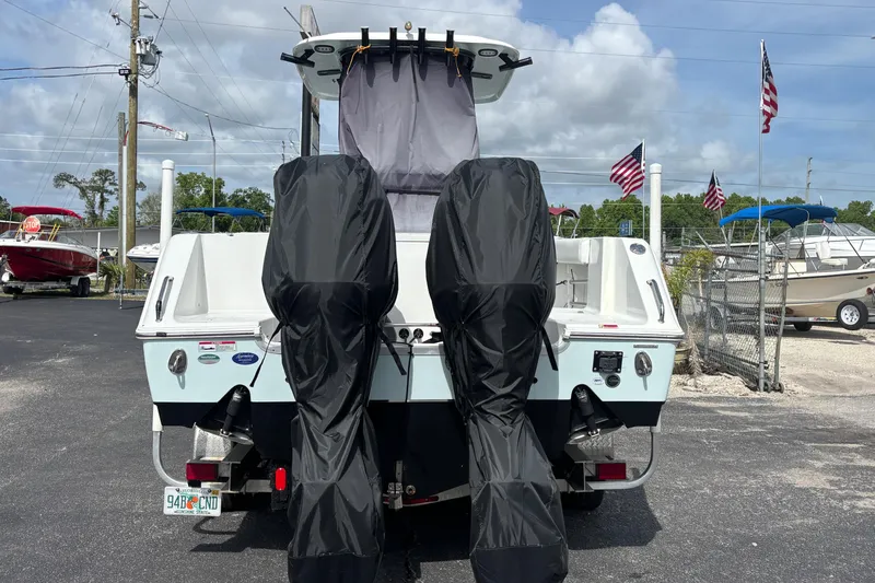 Slide: The Image of 2018 Sea Hunt Gamefish 27 boat with covered engines, parked outdoors. - 5