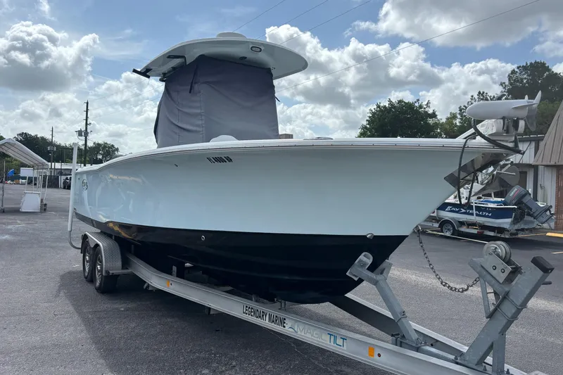 Slide: The Image of 2018 Sea Hunt Gamefish 27 boat on trailer under cloudy sky. - 7