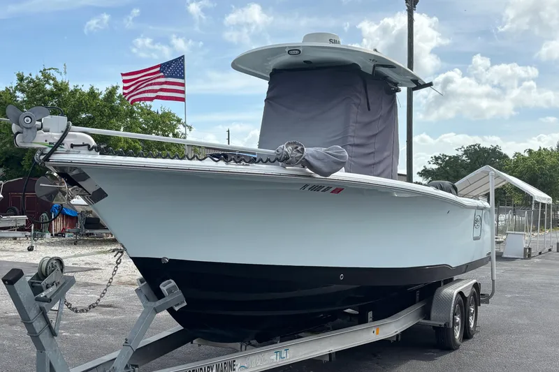 Slide: The Image of 2018 Sea Hunt Gamefish 27 boat on trailer, American flag in background. - 9