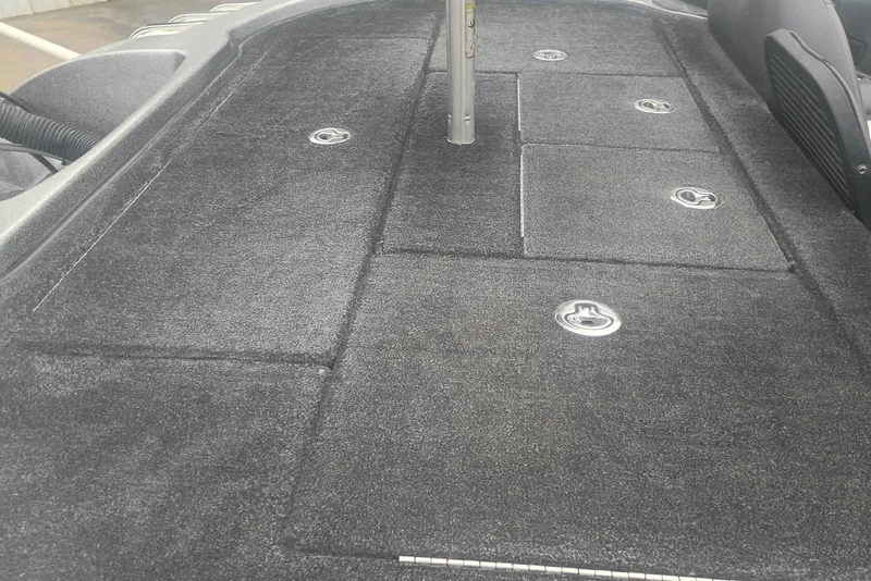 Slide: The Image of 2010 Ranger Z520 boat deck with storage compartments and carpeted surface. - 3