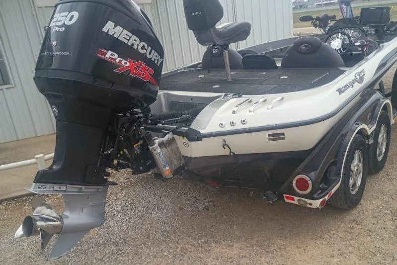 Slide: The Image of 2010 Ranger Z520 boat with Mercury Pro XS engine, parked on gravel. - 8