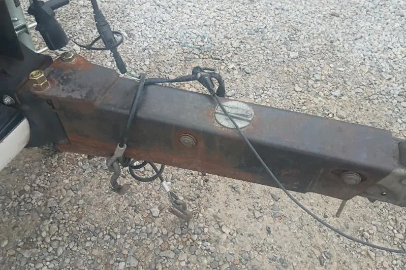 Slide: The Image of Rusty trailer hitch of a 2010 Ranger Z520 on gravel surface. - 9