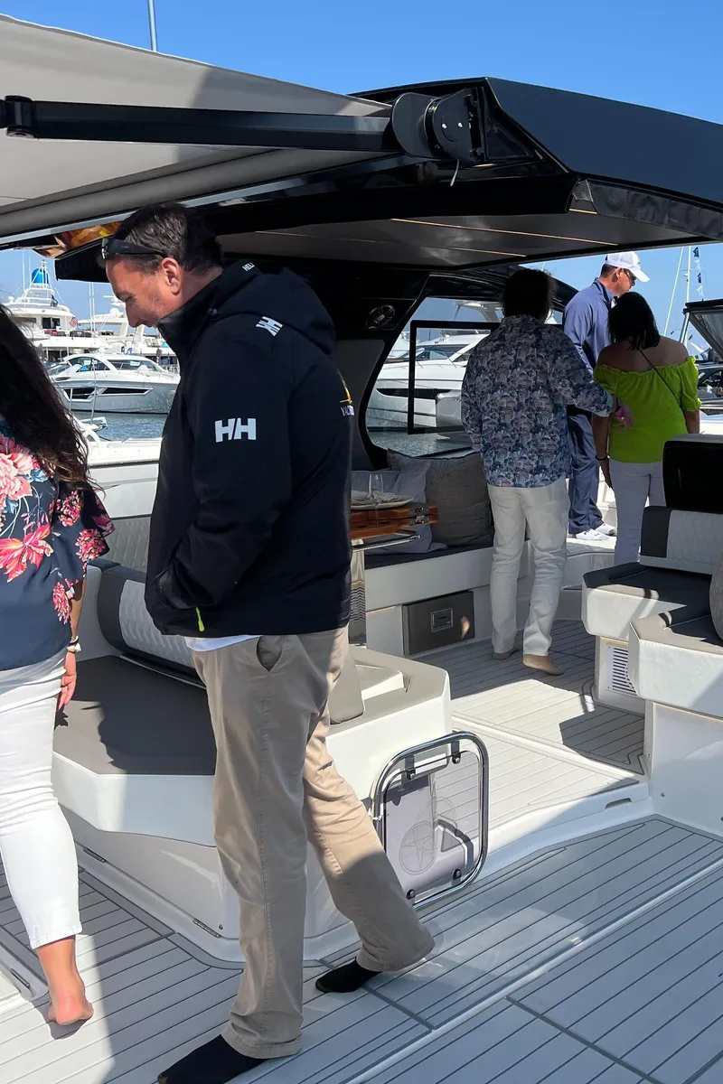 Slide: The Image of People exploring a Hanover 387 yacht, 2025 model, at a marina. - 19