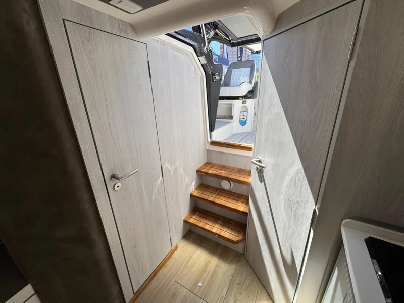 Slide: The Image of Interior of 2025 Hanover 387 boat with wooden steps and modern design. - 7