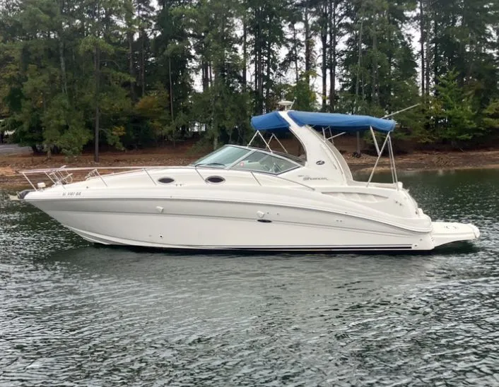 The Image of 2004 Sea Ray Sundancer 320 on calm water near trees. - 0