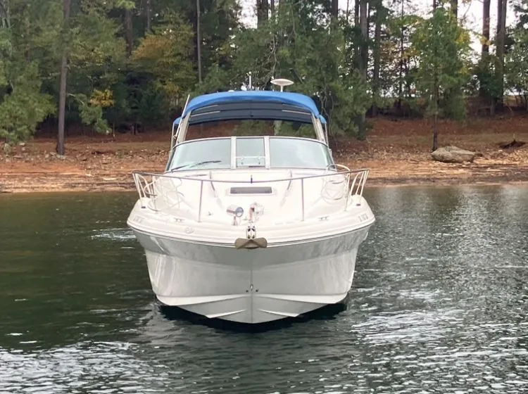 Slide: The Image of 2004 Sea Ray Sundancer 320 on calm water with forest backdrop. - 2