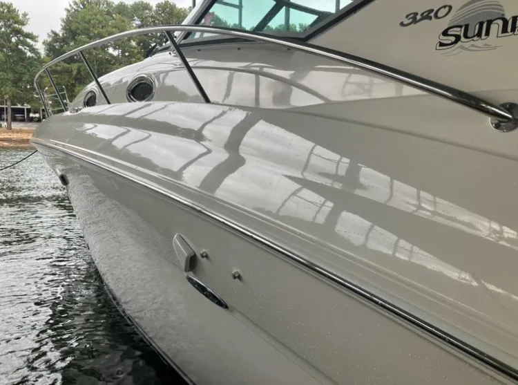 Slide: The Image of 2004 Sea Ray Sundancer 320 boat docked by the water. - 27