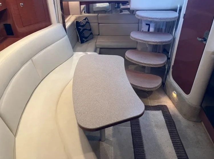 Slide: The Image of Interior of a 2004 Sea Ray Sundancer 320 with curved sofa and stairs. - 32