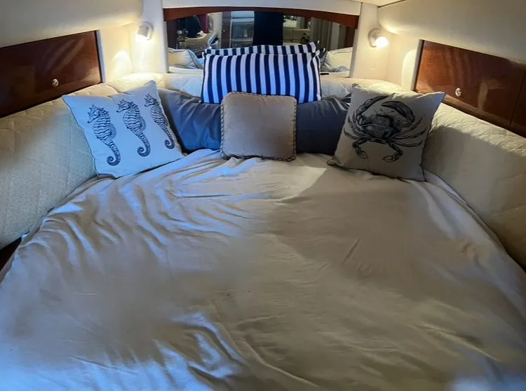 Slide: The Image of Interior of a Sea Ray Sundancer 320 yacht, cozy bed with nautical-themed pillows. - 33