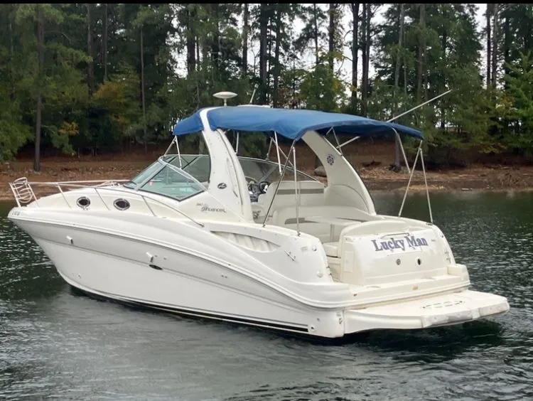 Slide: The Image of 2004 Sea Ray Sundancer 320 boat on calm water with blue canopy. - 6